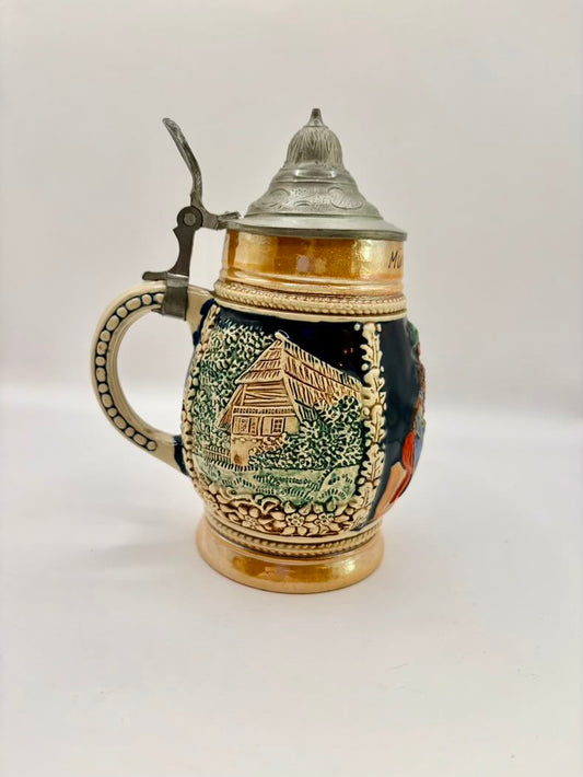Decorative ceramic stein with lid on a white background
