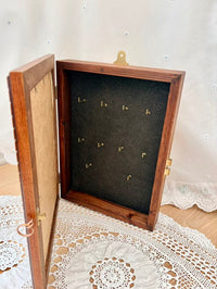 Wooden keys box with hooks holders on a lace tablecloth