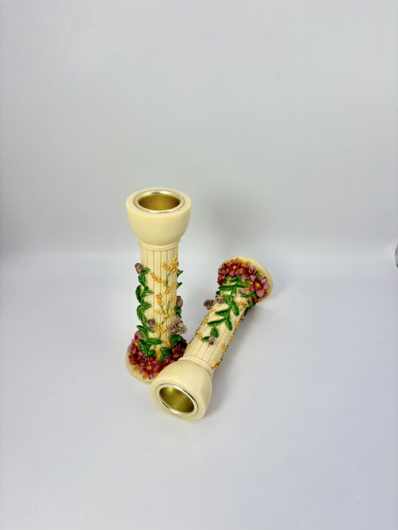 Decorative shell with embedded red and green stones on a light gray background