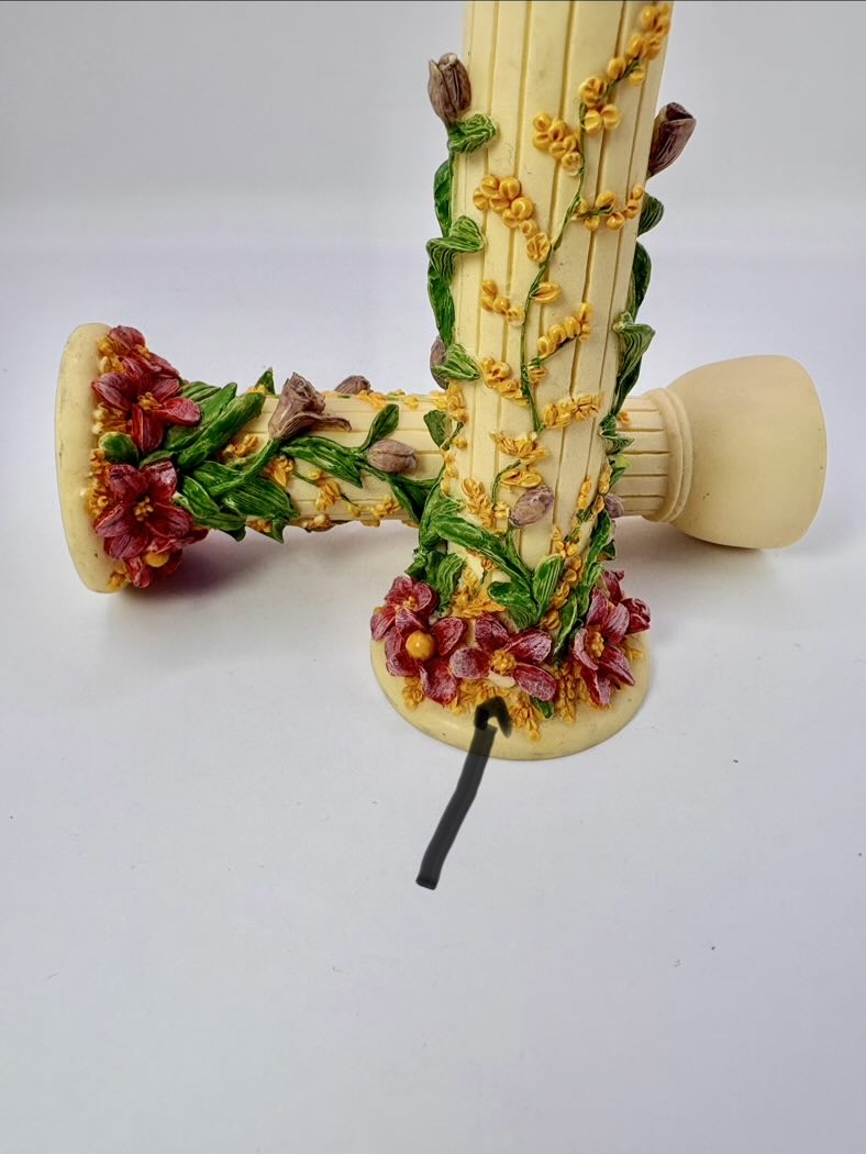 Decorative phone receiver with floral designs on a white background