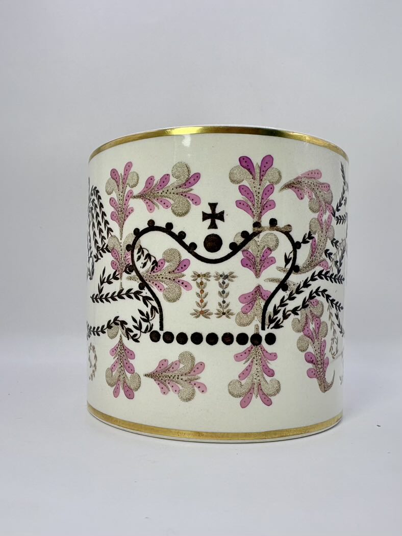 Decorative cylindrical container with floral patterns on a white background
