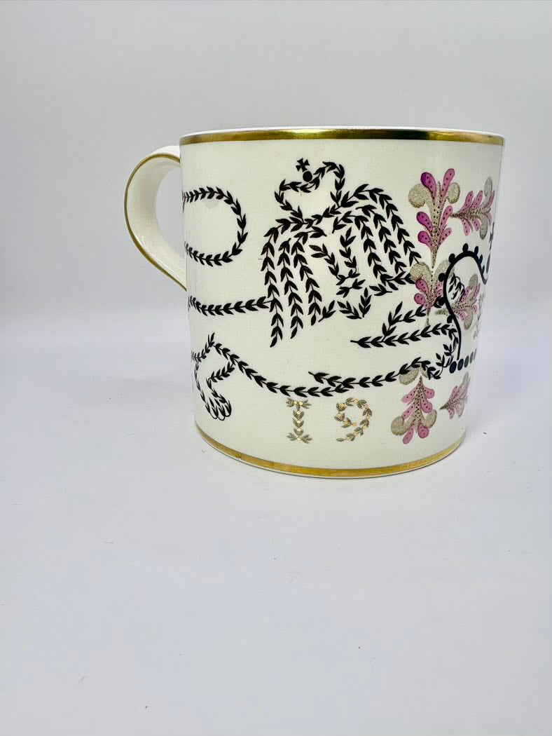 Decorative mug with black floral patterns on a white background