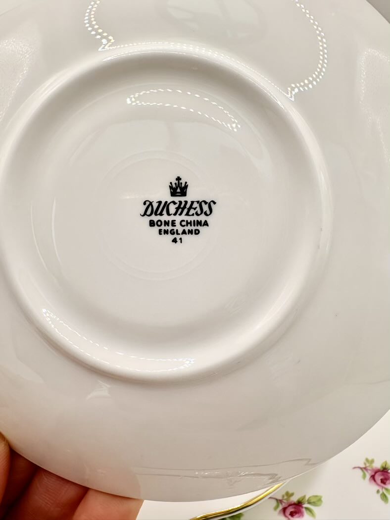 Close-up of a Duchess bone china plate with branding.