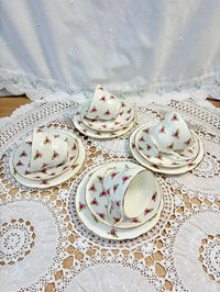 Tea set with floral patterns on a lace tablecloth