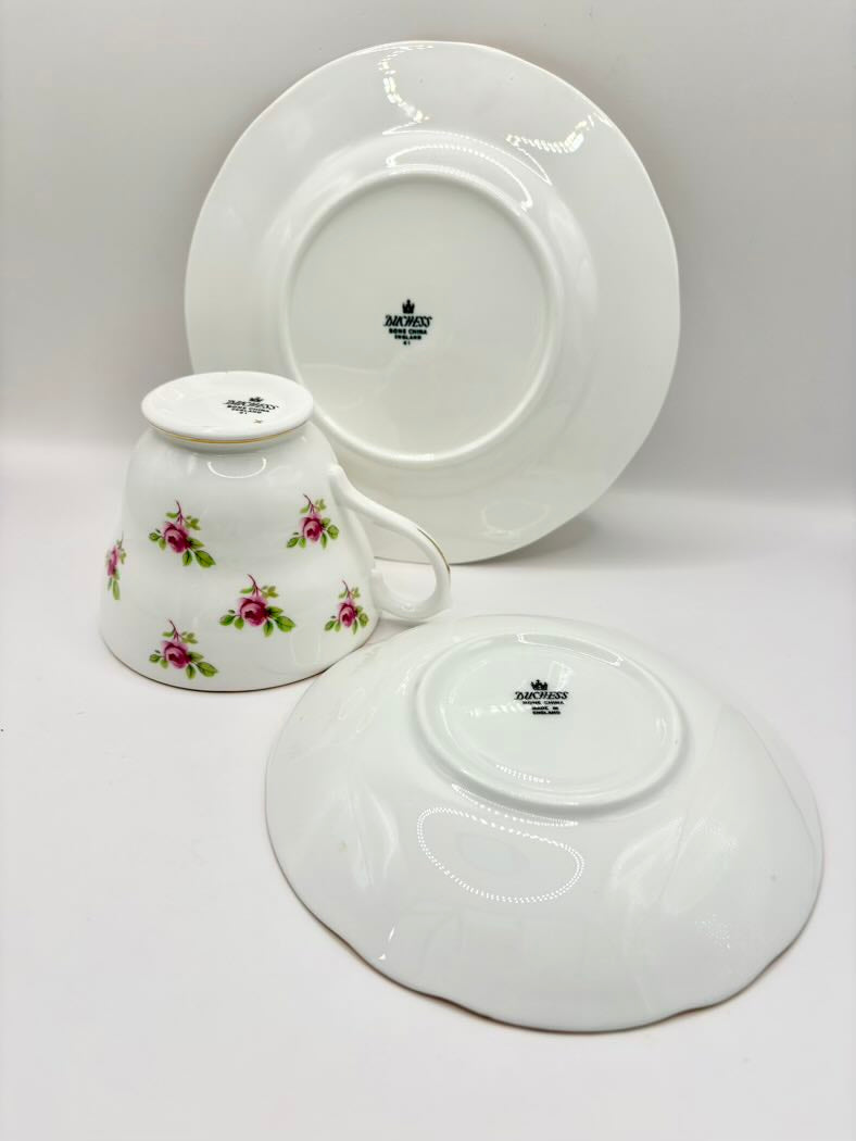 White ceramic teacup and saucer set with floral design on a white background