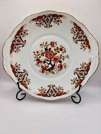 Decorative plate with floral and leaf patterns on a white background