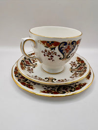 Decorative teacup and saucer with intricate patterns on a white background