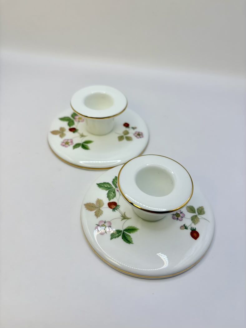 Two decorative candle holders with floral patterns on a white background