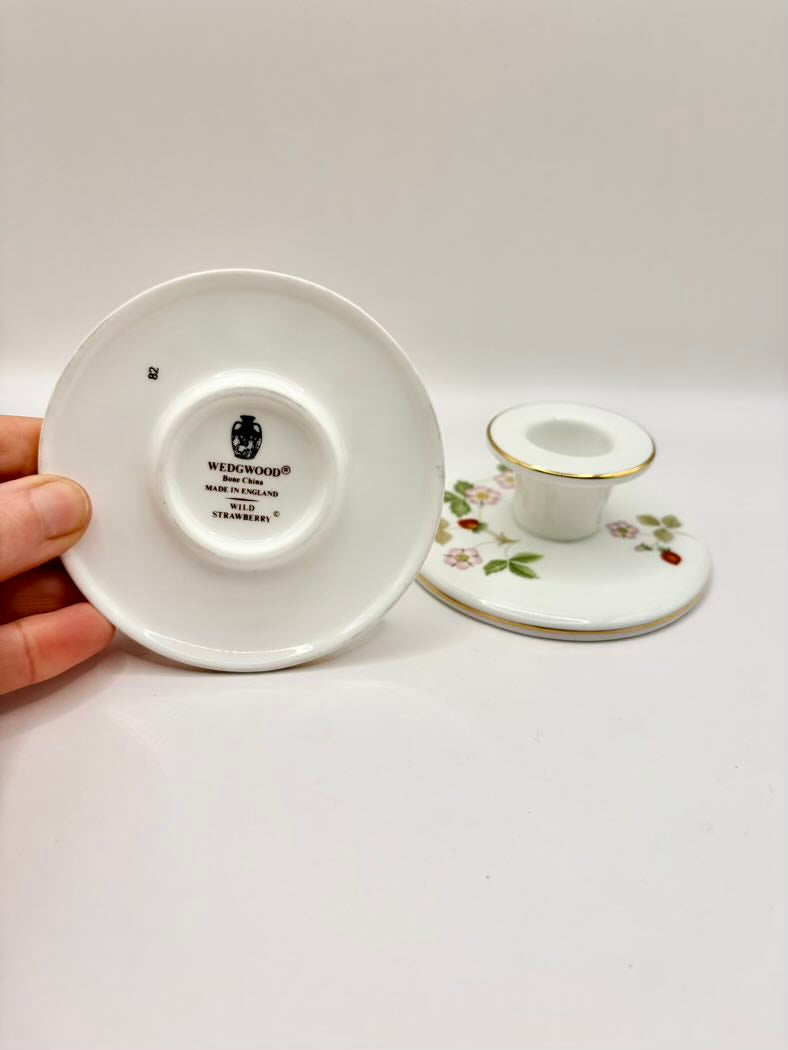 White ceramic saucer with a visible brand logo on a white background