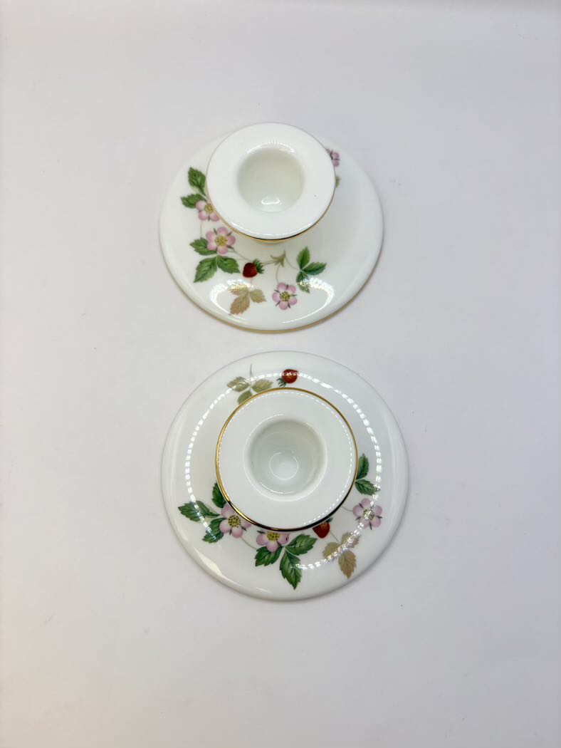 Two decorative glass coasters with floral patterns on a white background
