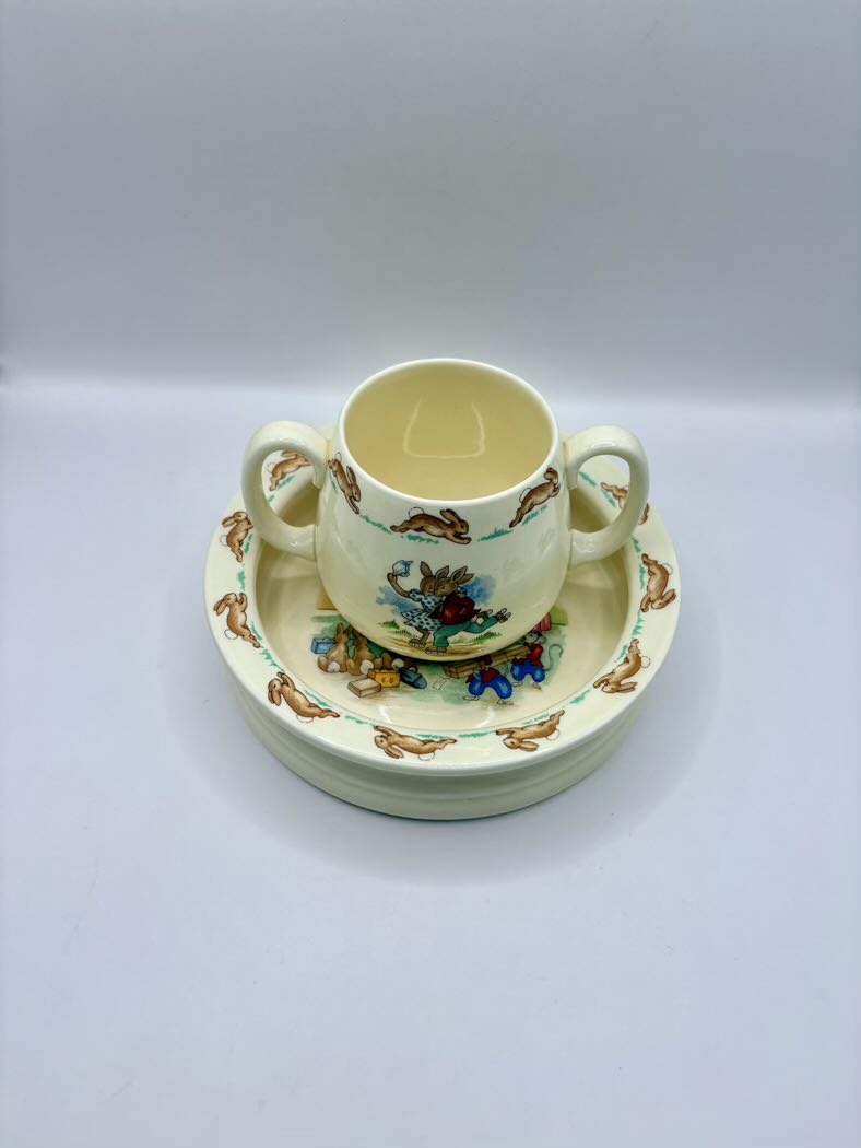 Ceramic cup and saucer set with floral design on a white background
