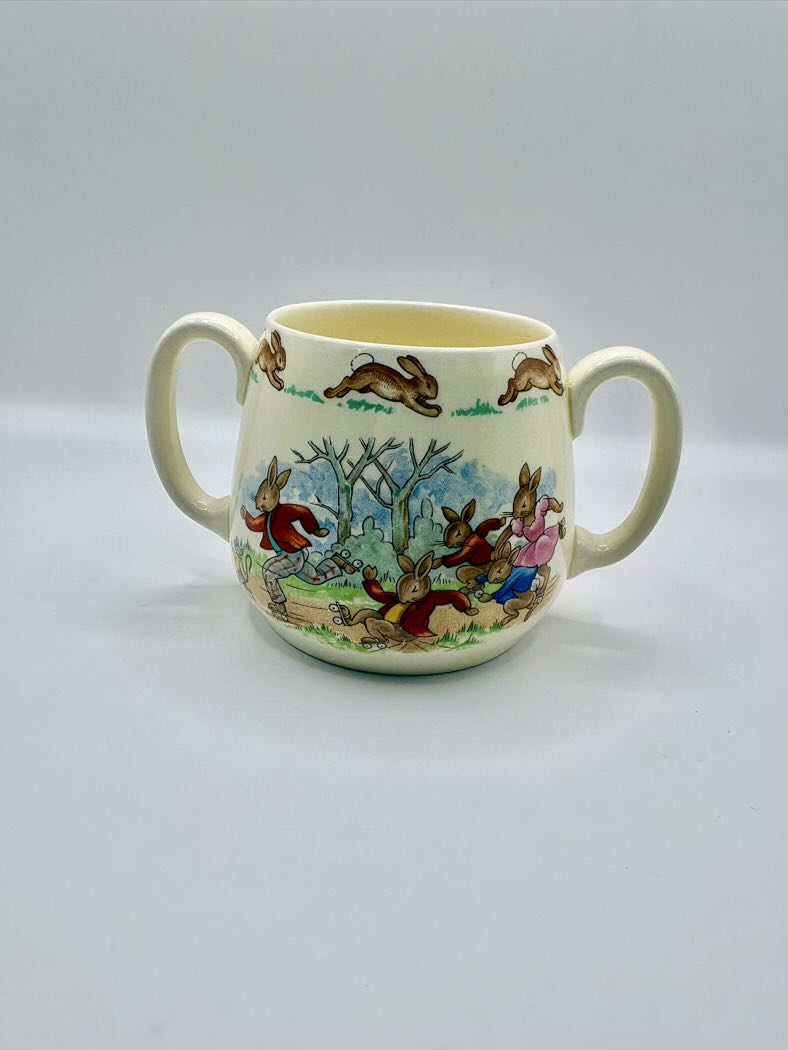Ceramic mug with rabbit illustrations on a plain background