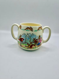 Ceramic mug with rabbit illustrations on a plain background