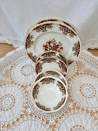 Set of ceramic plates with floral design on a lace tablecloth