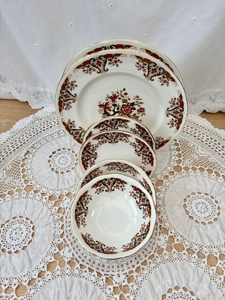 Set of ceramic plates with floral design on a lace tablecloth