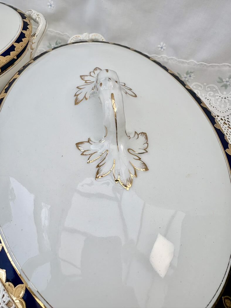 Decorative plate with gold leaf design on a white background