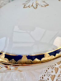 Close-up of a decorative teacup with gold and blue accents.