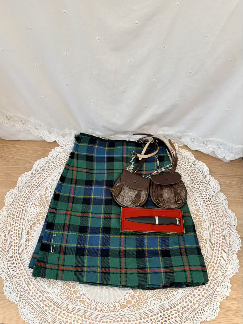 Plaid kilt with accessories on a lace doily