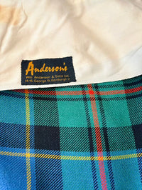 Close-up of Anderson's label on a plaid fabric background