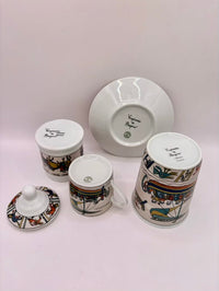 Set of ceramic items with decorative patterns on a white background