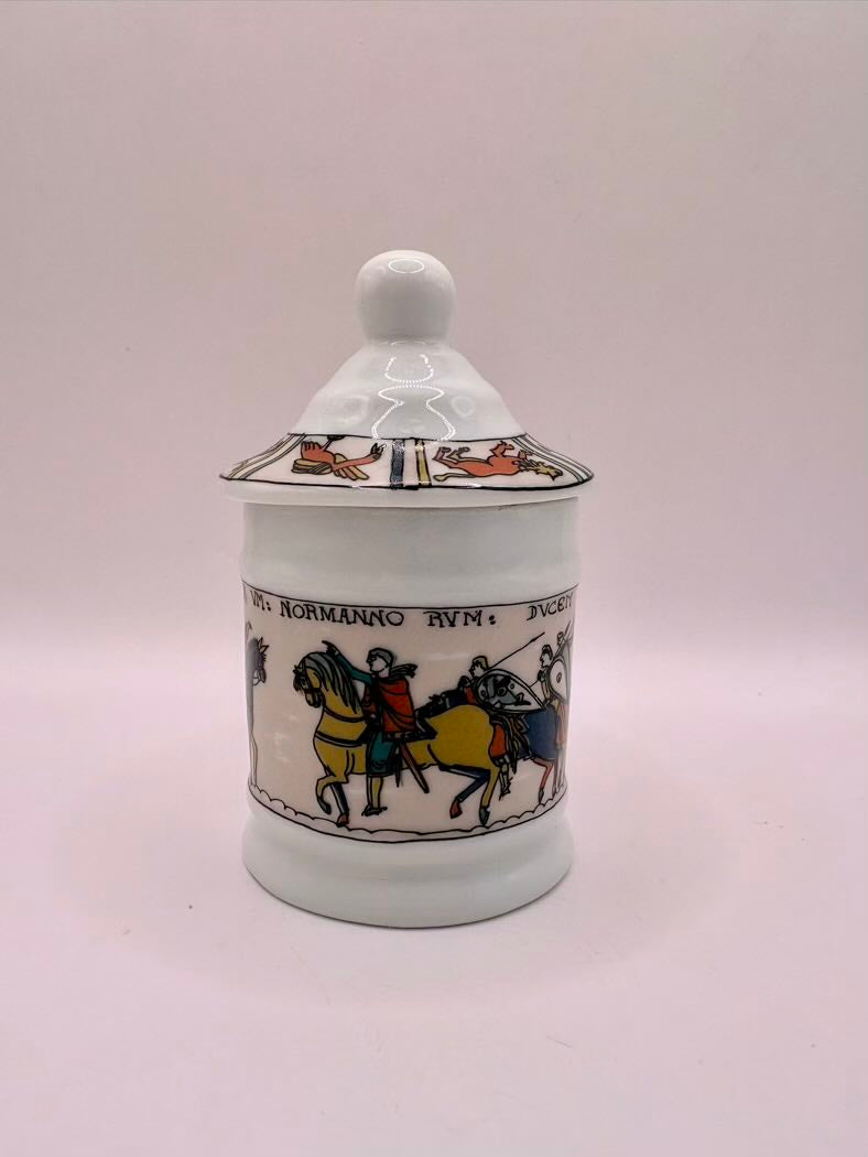 Decorative ceramic jar with lid on a white background