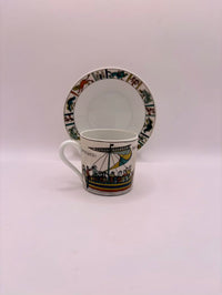 Ceramic mug and saucer with decorative patterns on a white background