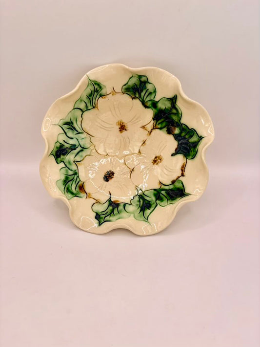 Ceramic plate with floral design on a plain background