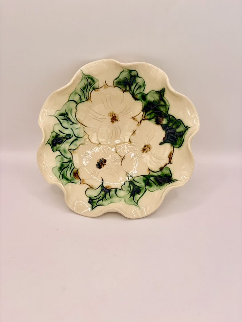 Ceramic plate with floral design on a plain background