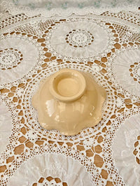 Beige ceramic bowl on a lace tablecloth