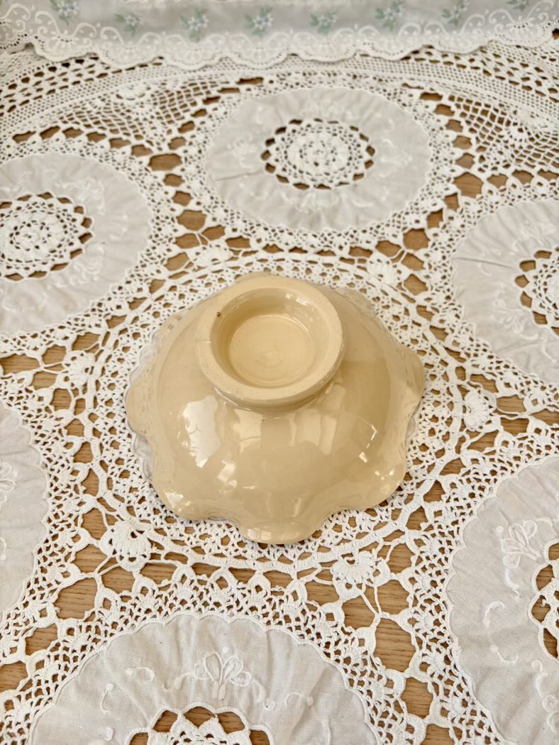 Beige ceramic bowl on a lace tablecloth