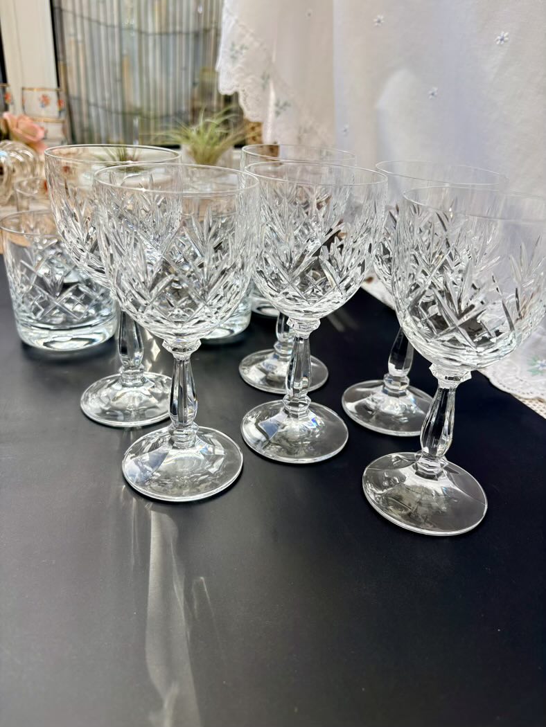 Set of crystal wine glasses on a dark surface with blurred background