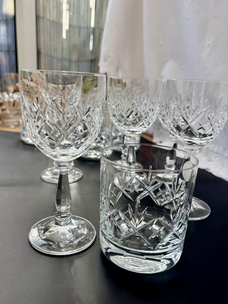 Set of crystal glasses on a dark surface with blurred background