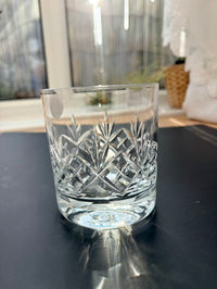 Crisp clear glass with intricate patterns on a reflective surface