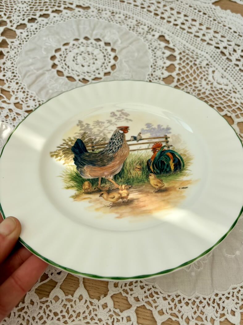 Decorative plate with chicken design on a lace tablecloth