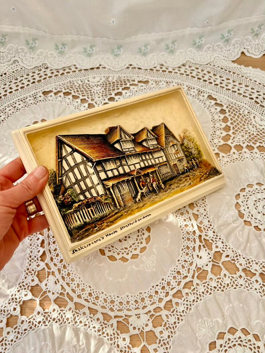 A detailed carving of a house on a lace tablecloth