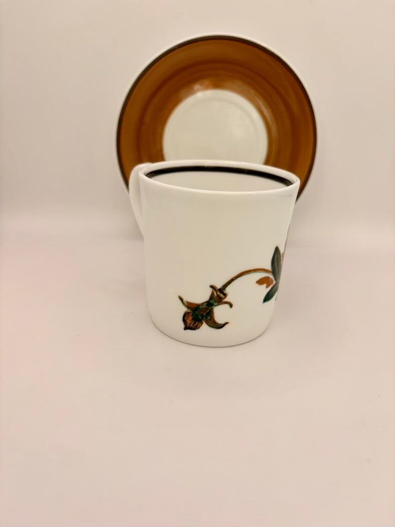 White mug with floral design on a beige background