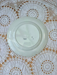 White ceramic plate on a lace tablecloth