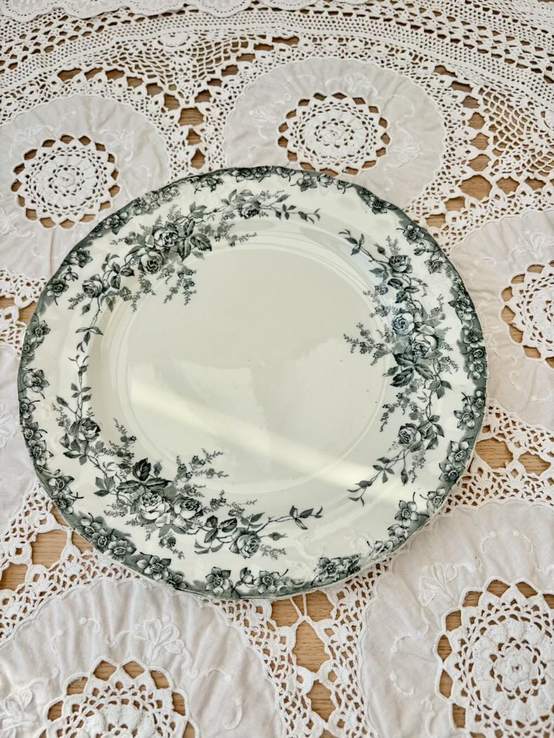 Decorative plate with floral pattern on a lace tablecloth