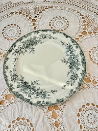 Decorative plate with floral pattern on a lace tablecloth