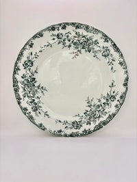 White plate with black floral pattern on a white background