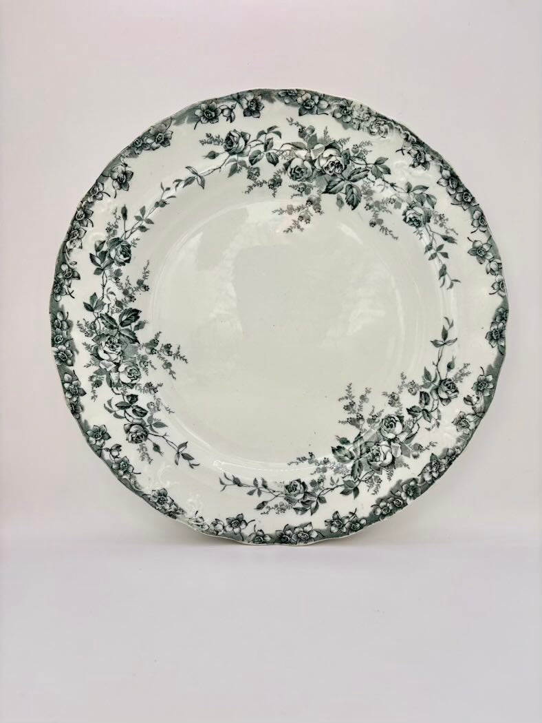 White plate with black floral pattern on a white background