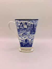 Blue and white mug with architectural design on a light gray background