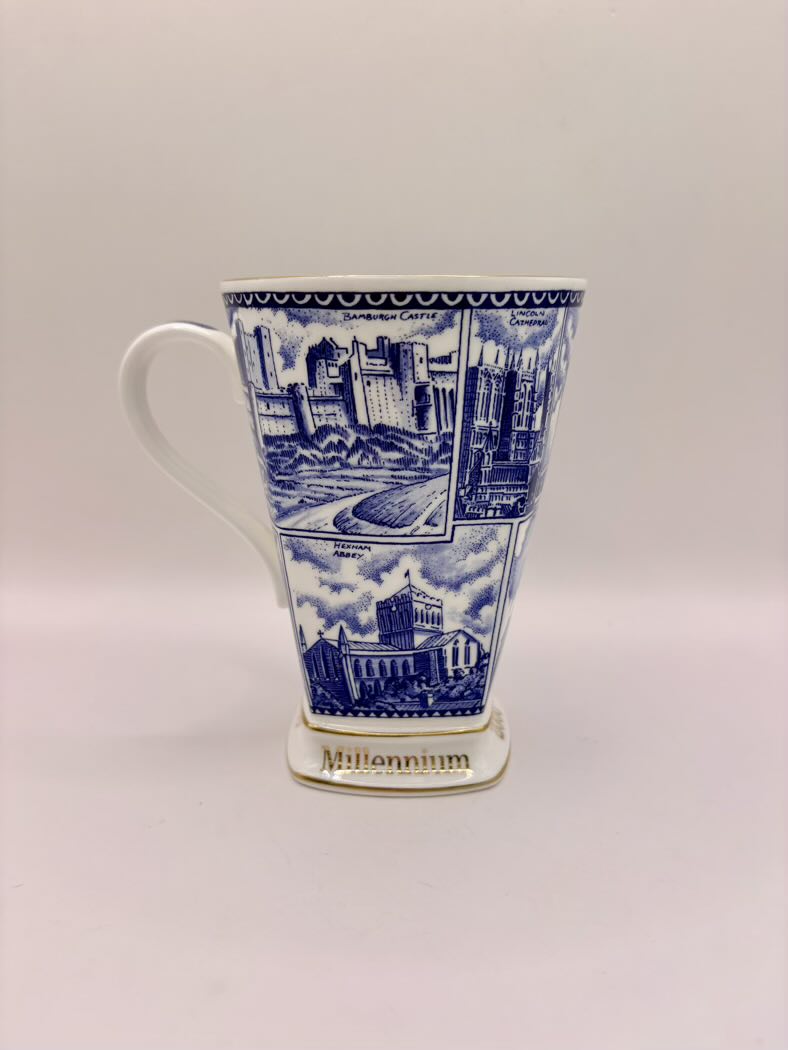 Blue and white mug with architectural design on a light gray background