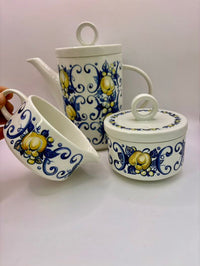 Set of ceramic containers with blue and yellow floral patterns on a white background