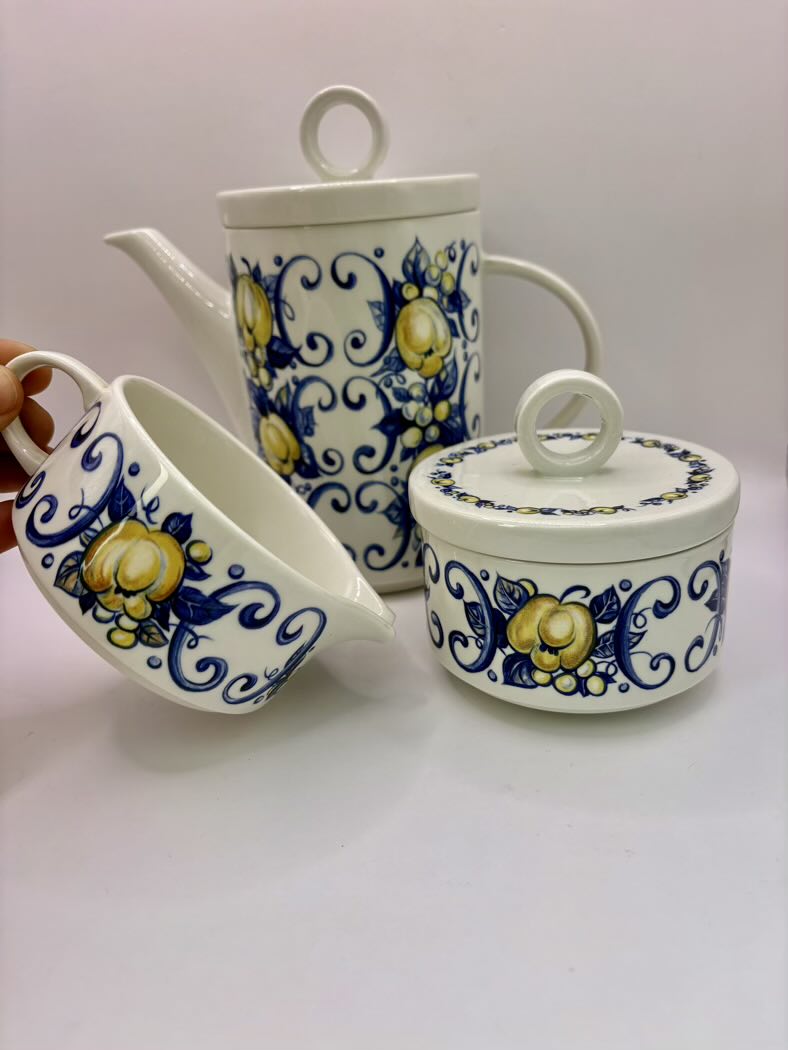 Set of ceramic containers with blue and yellow floral patterns on a white background