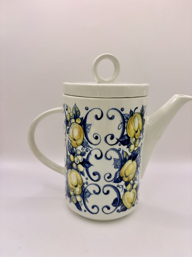 Ceramic teapot with lemon and swirl design on a white background