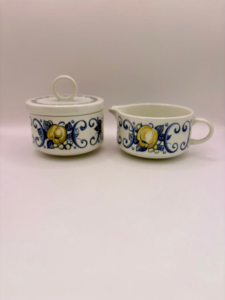 Two ceramic containers with floral designs on a white background