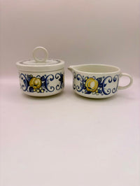 Two ceramic containers with floral designs on a white background