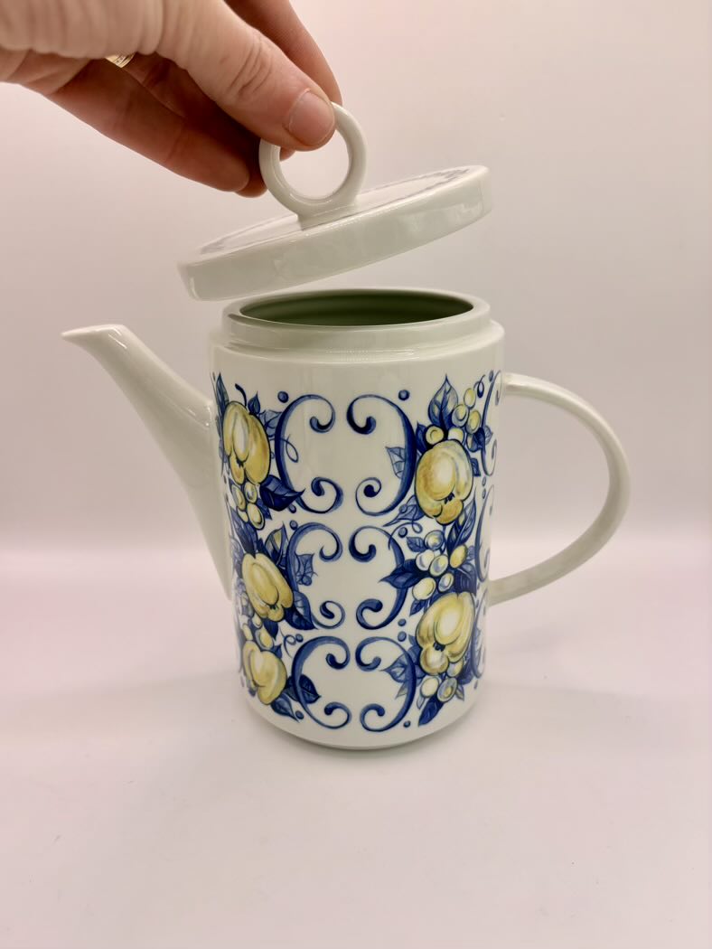 Ceramic teapot with blue floral design on a white background