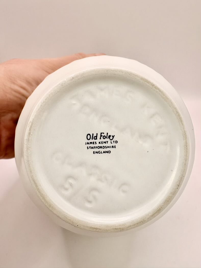 Close-up of a ceramic product with 'Old Foley' branding on a plain background